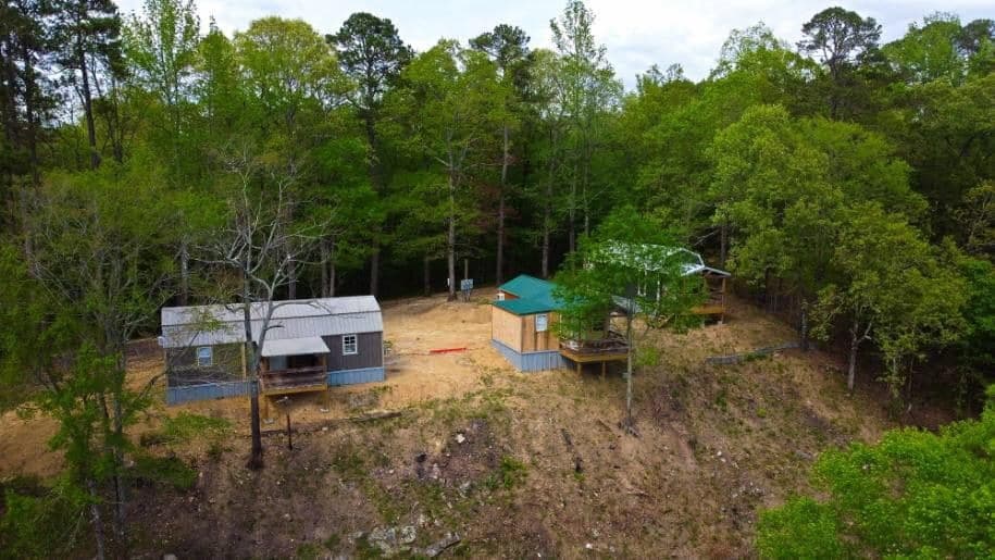 Aerial view of Lucky's cabins surrounded by woods near the Caddo River